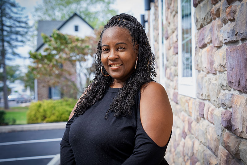 headshot of patient smiling brightly after their dental treatment