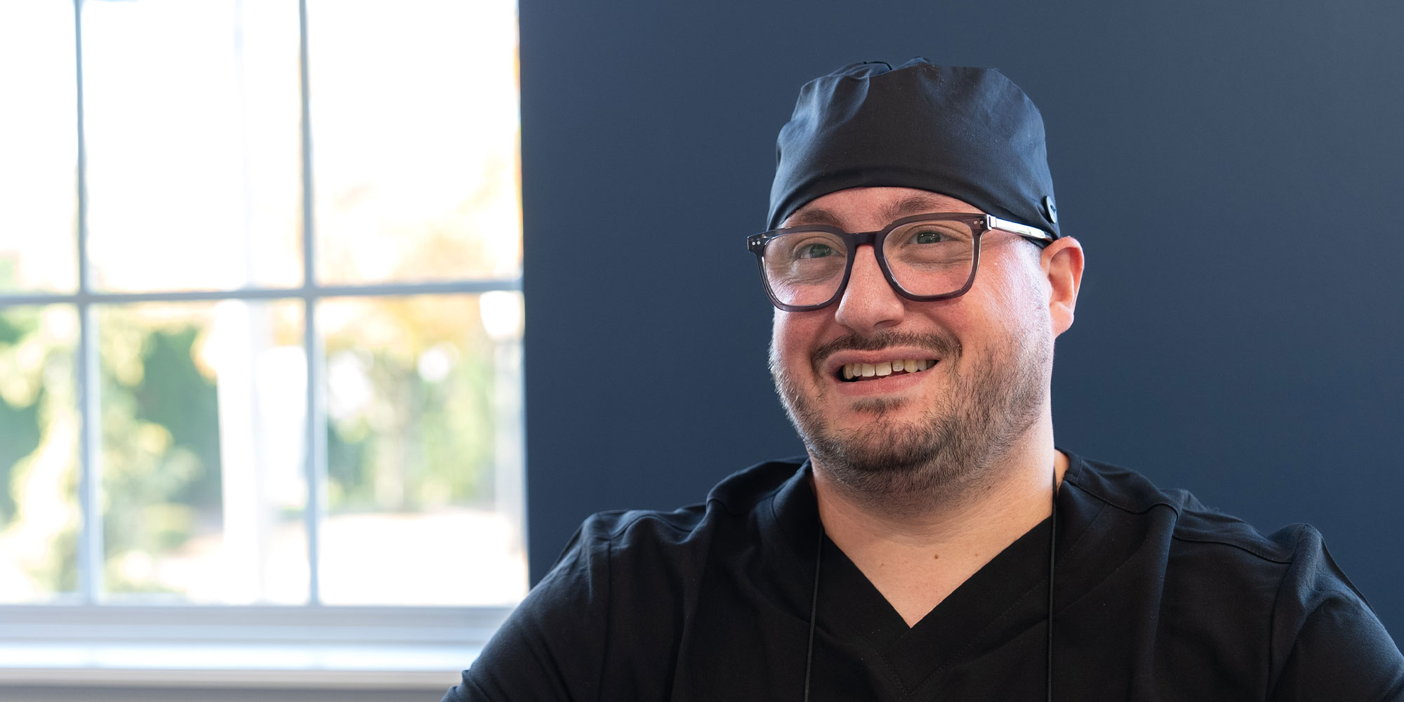 doctor smiling while going over dental procedure information with patient