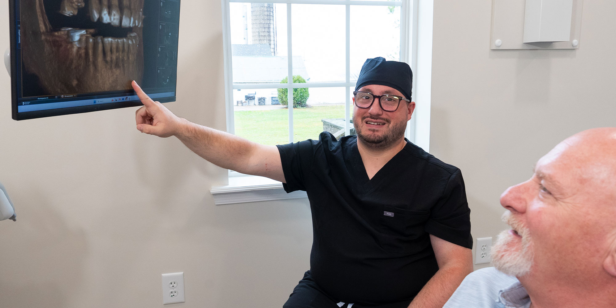 doctor going over dental procedure information with patient