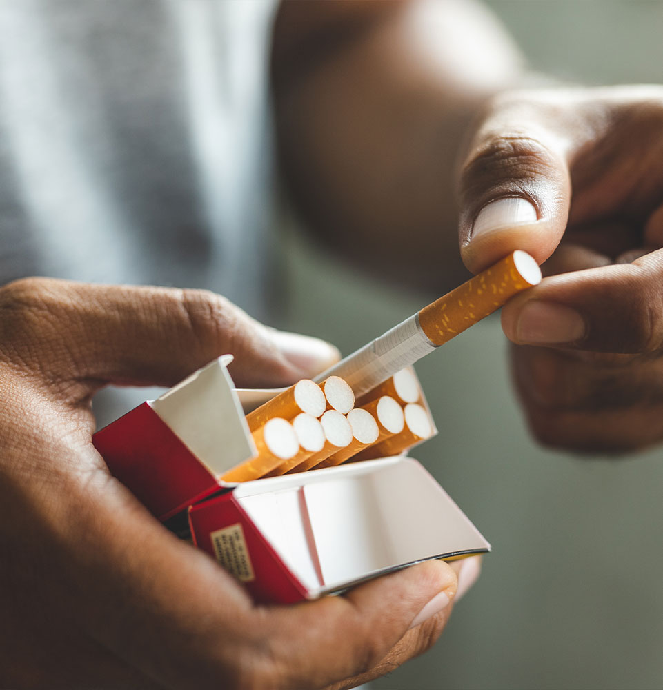 close up of a person taking out a cigarette