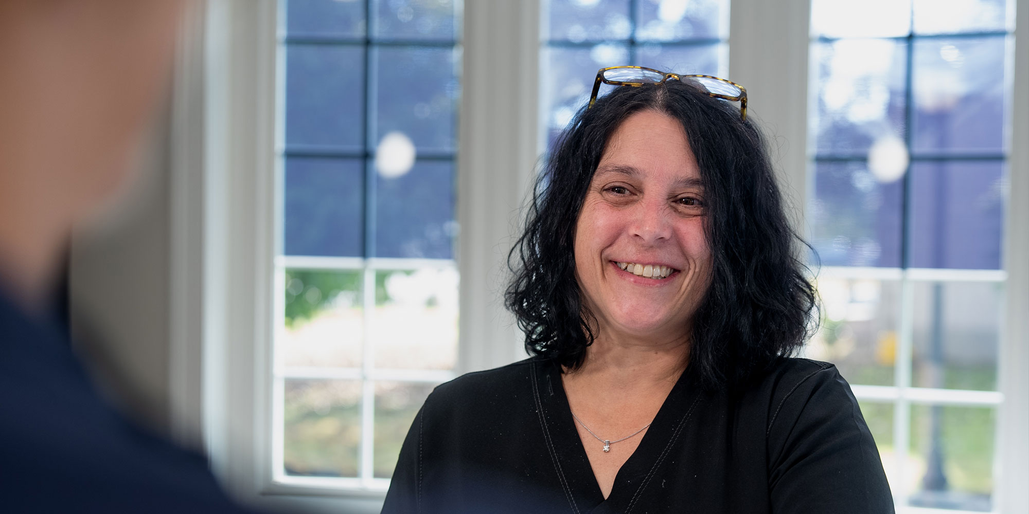 staff member helping patient at the front desk of the dental center