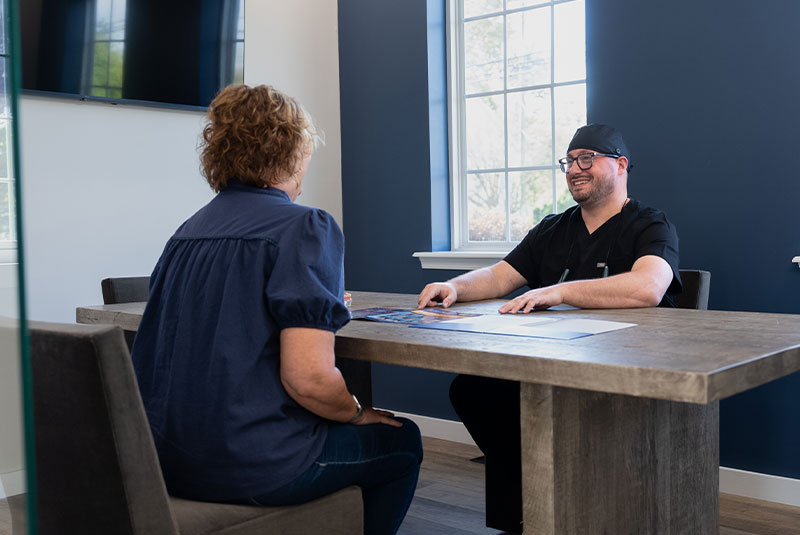 patient and doctor going over over dental treatment info in consultation
