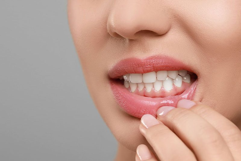 close up of person having gum pain and aches