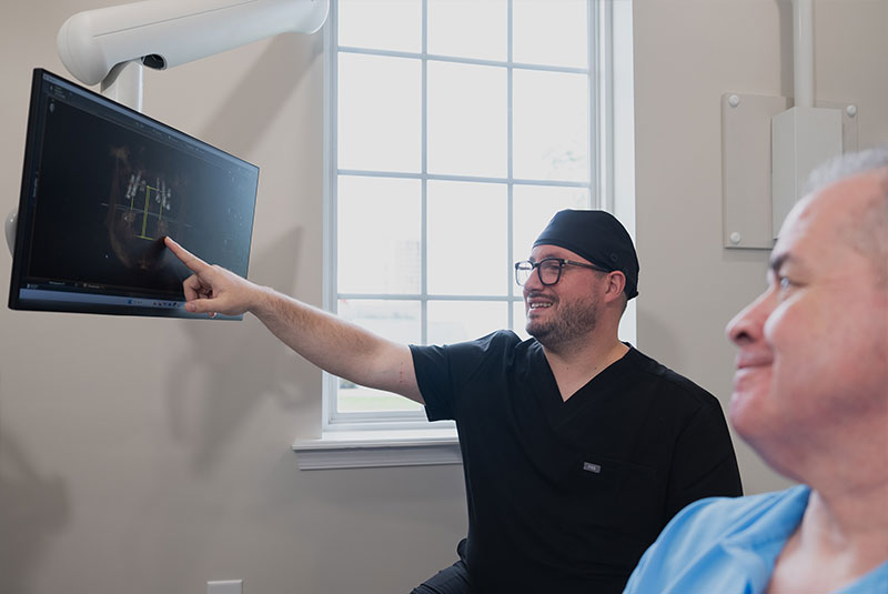 doctor going over dental treatment information with patient within the dental center