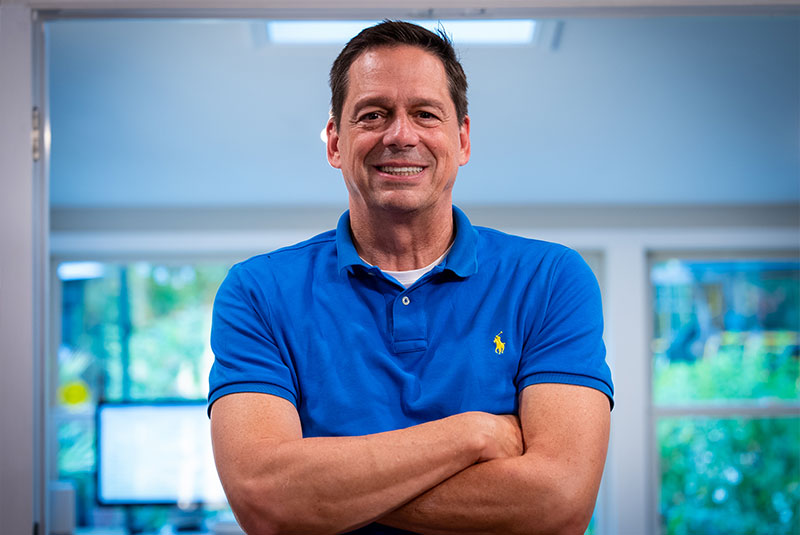 headshot of patient smiling brightly