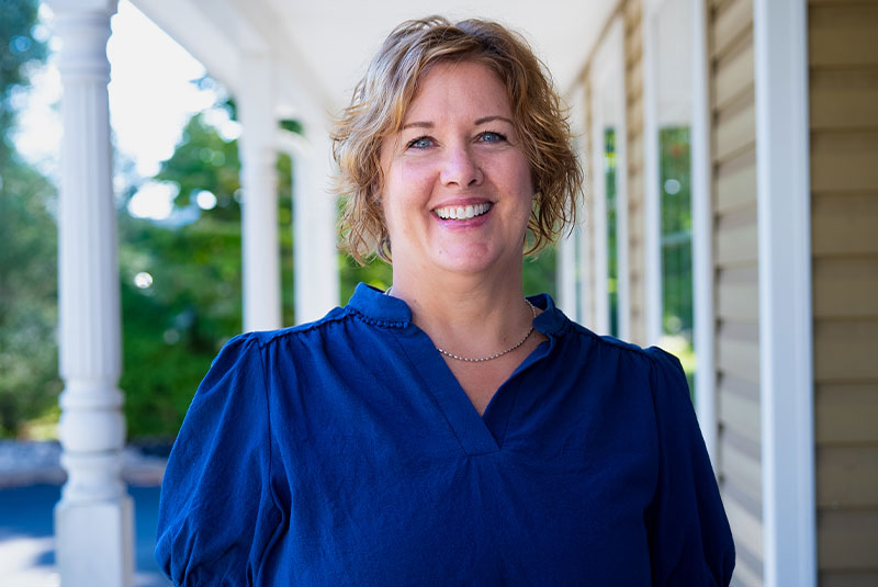 headshot of patient smiling brightly after their dental treatment