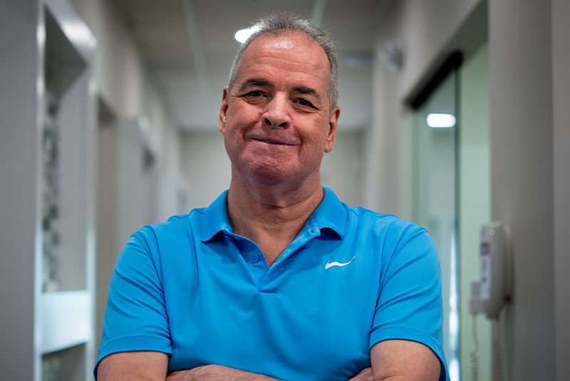 headshot of patient smiling brightly after their dental implant treatment