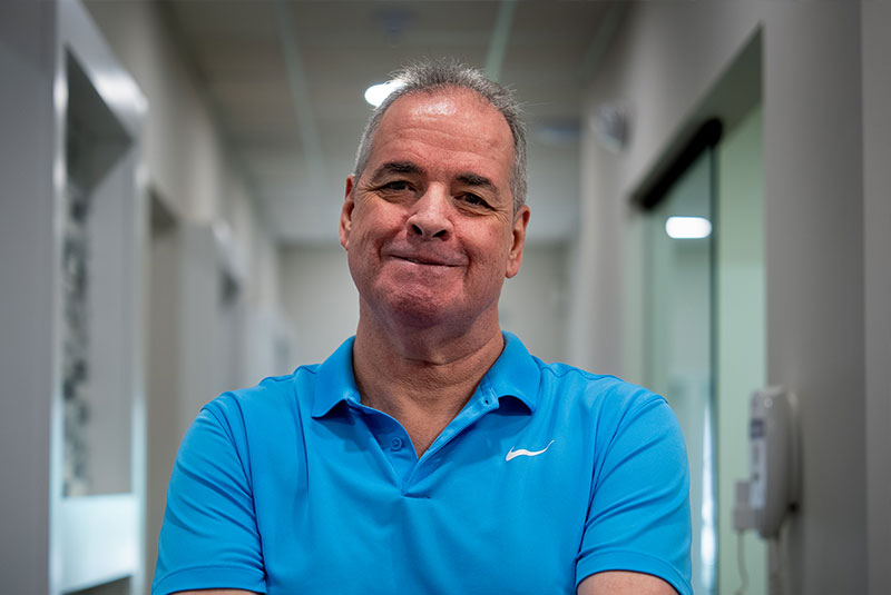 headshot of patient smiling brightly after their dental implant treatment